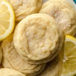 Aerial photo of lemon sugar cookies on a plate with lemon slices