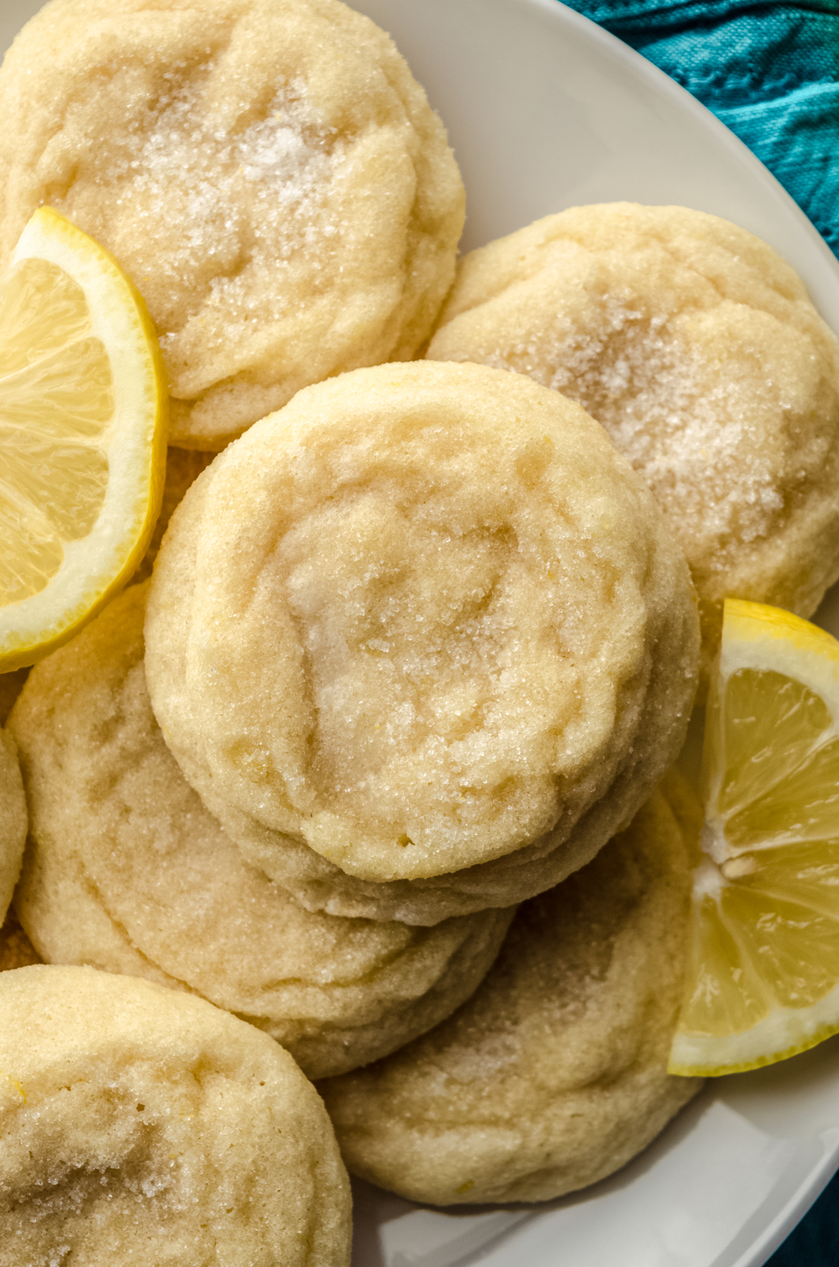 Aerial photo of lemon sugar cookies on a plate with lemon slices