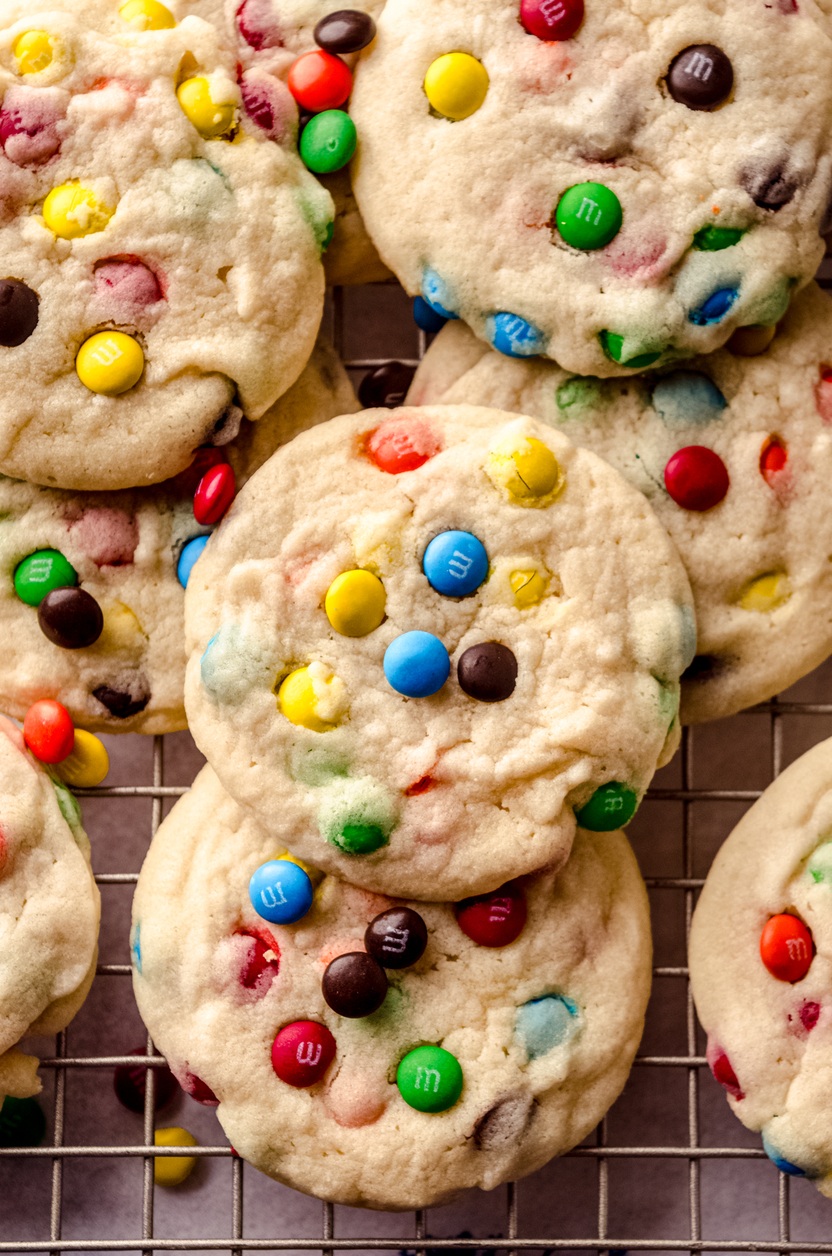 Aerial photo of m&m cookies on a cooling rack.