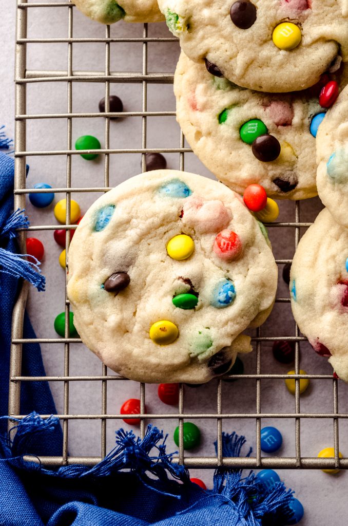 Aerial photo of m&m cookies on a cooling rack.