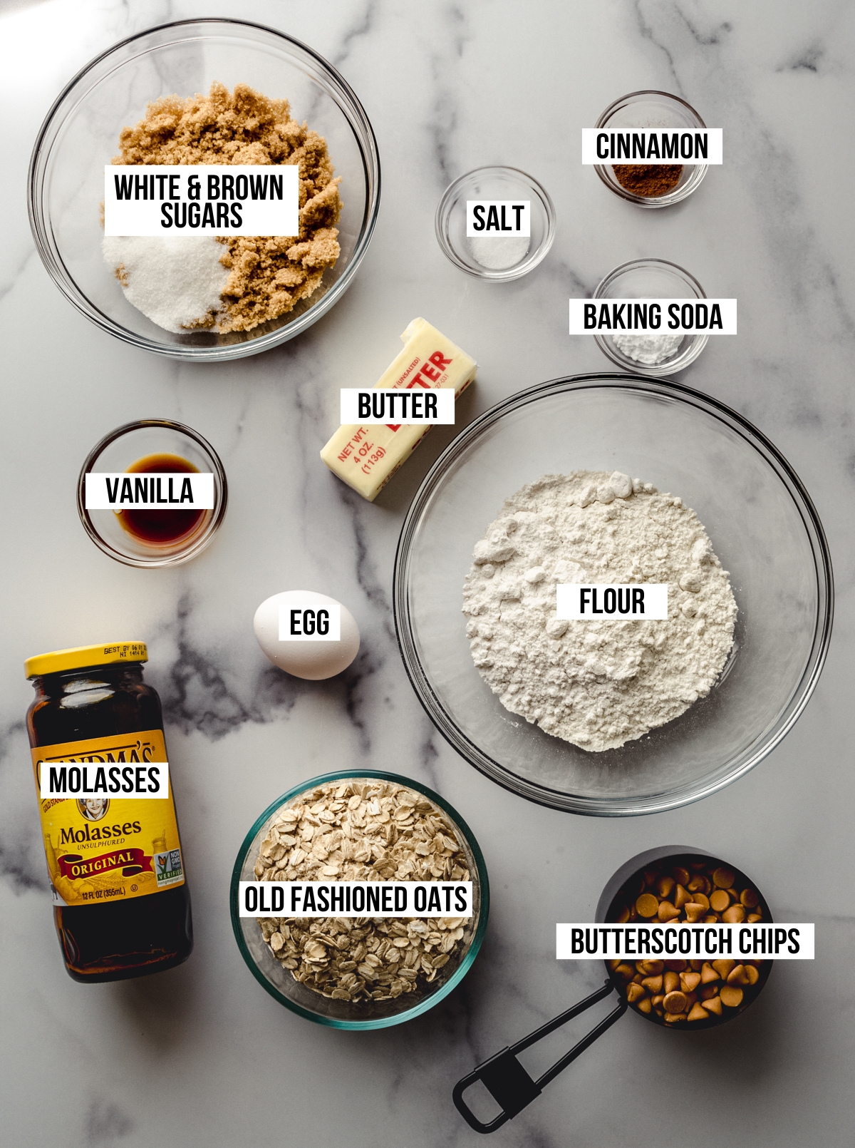 Aerial photo of ingredients to make oatmeal scotchies with text overlay labeling each ingredient. 