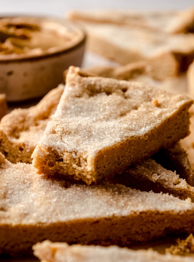 A piece of peanut butter shortbread with a bite taken out of it.