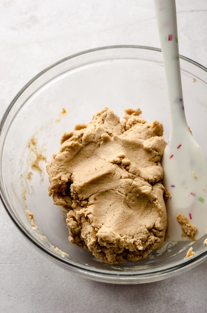 A bowl of peanut butter shortbread dough.