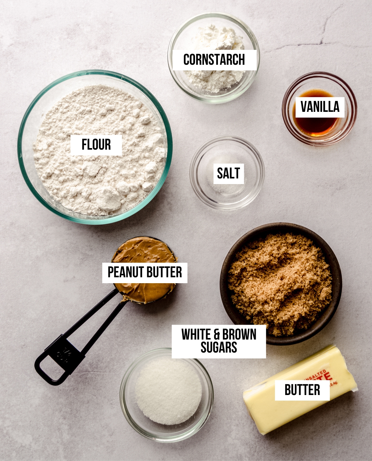 Aerial photo of ingredients to make peanut butter shortbread with text overlay labeling each ingredient.