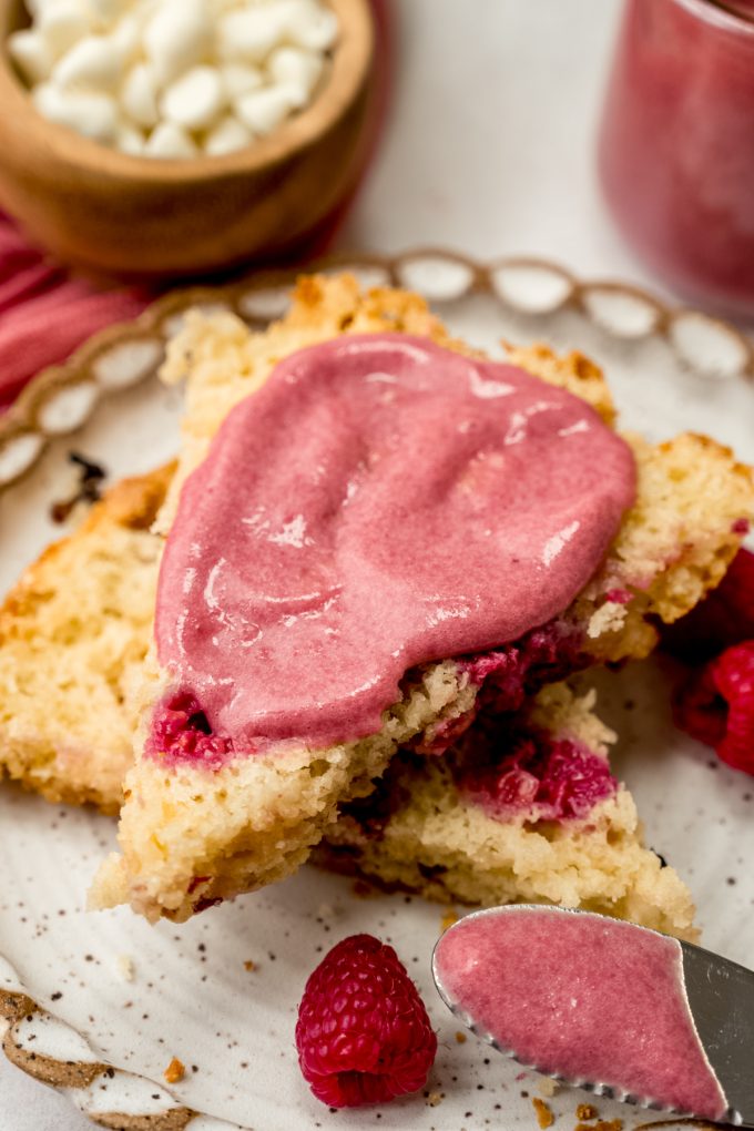 A scone with raspberry curd on it.