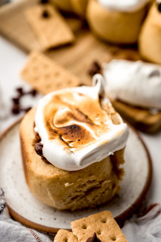 A s'mores cinnamon roll on a plate.
