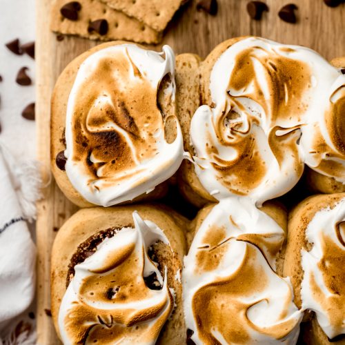 S'mores cinnamon rolls in a cutting board.