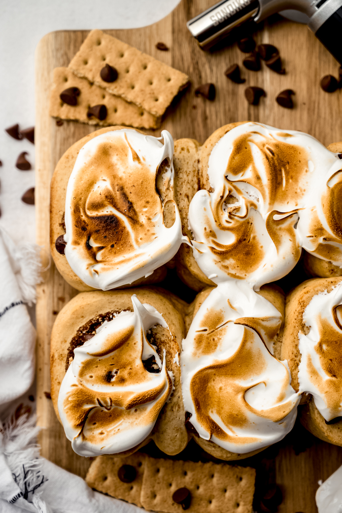 S'mores cinnamon rolls in a cutting board.
