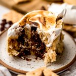 A s'mores cinnamon roll on a plate.