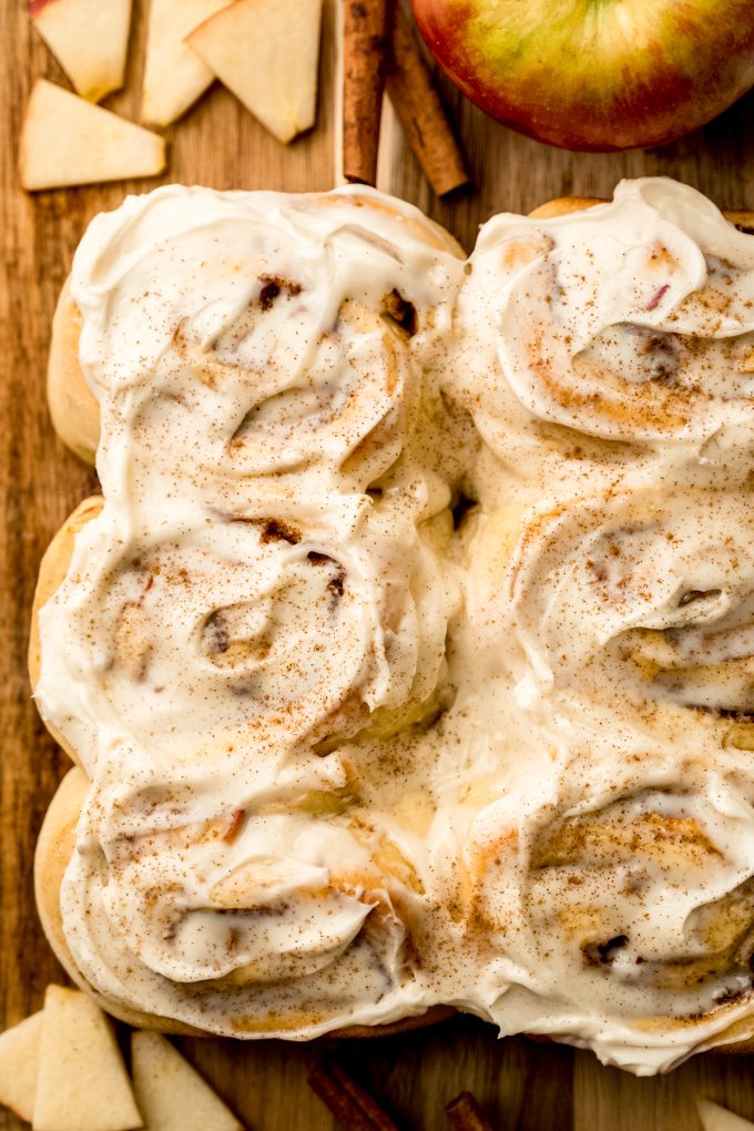 Aerial photo of apple cinnamon rolls on a cutting board.