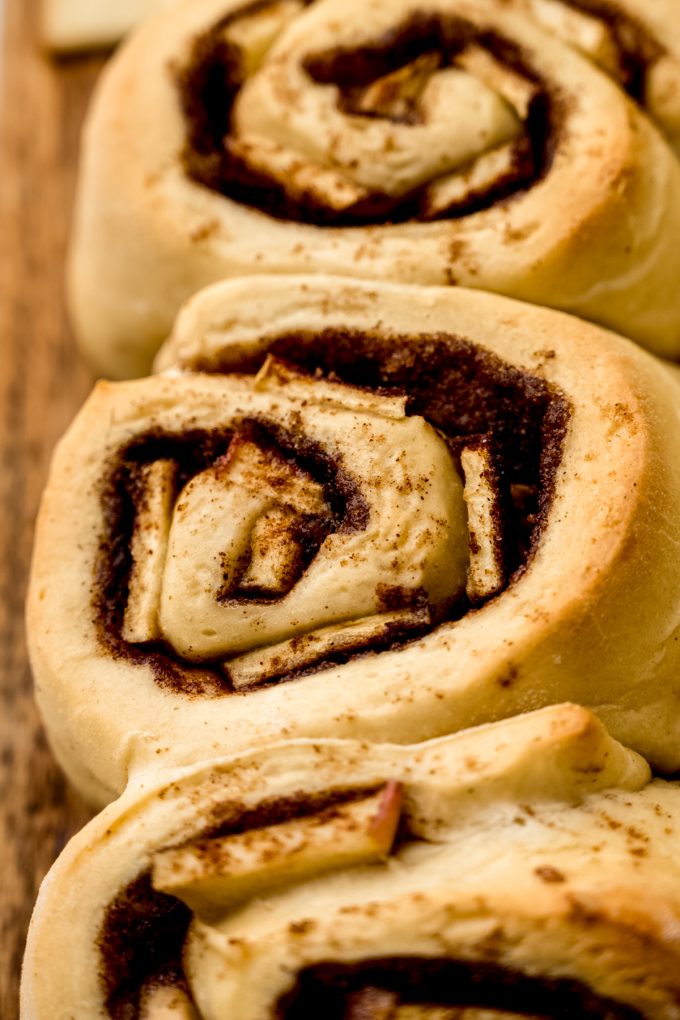 Apple cinnamon rolls that have been baked without frosting on them yet.
