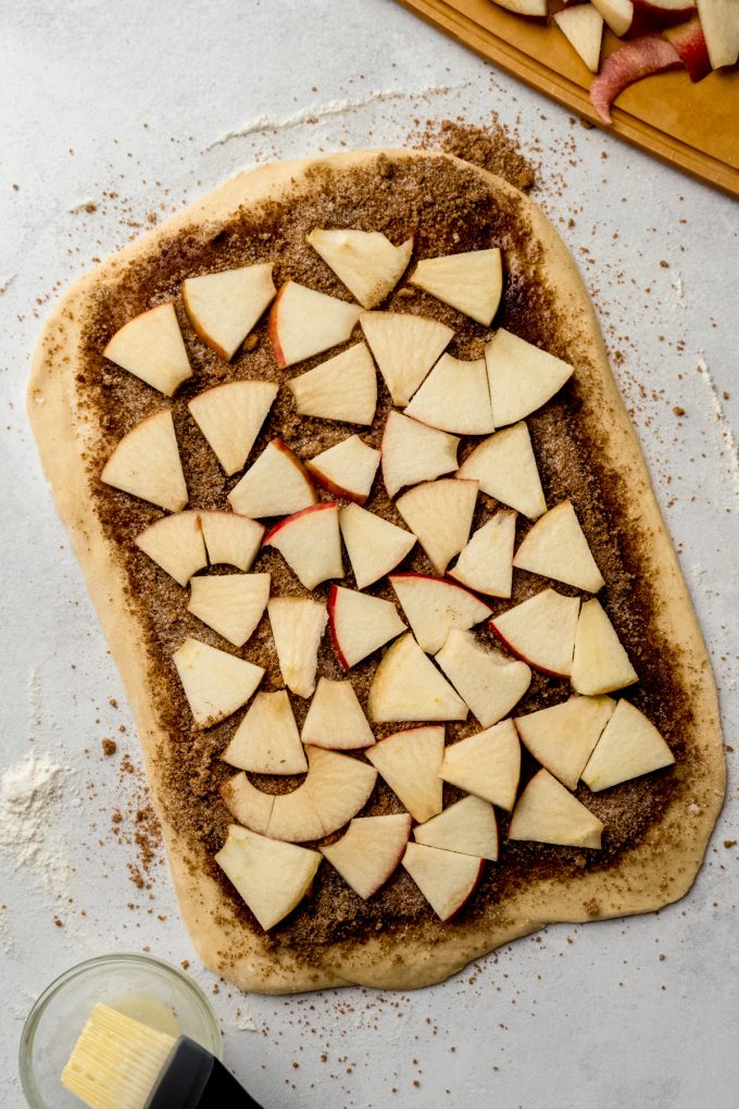 Aerial photo of a rectangle of dough to make apple cinnamon rolls.