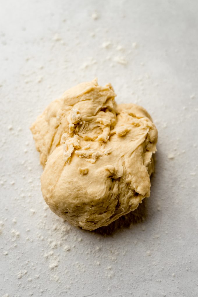 A ball of yeasted cinnamon roll rough before it's been kneaded.