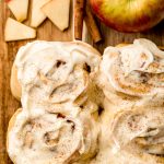 Aerial photo of apple cinnamon rolls on a cutting board.