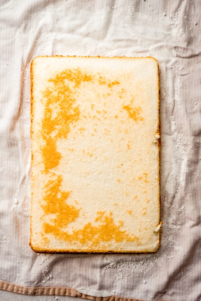 A layer of cake on a kitchen towel.