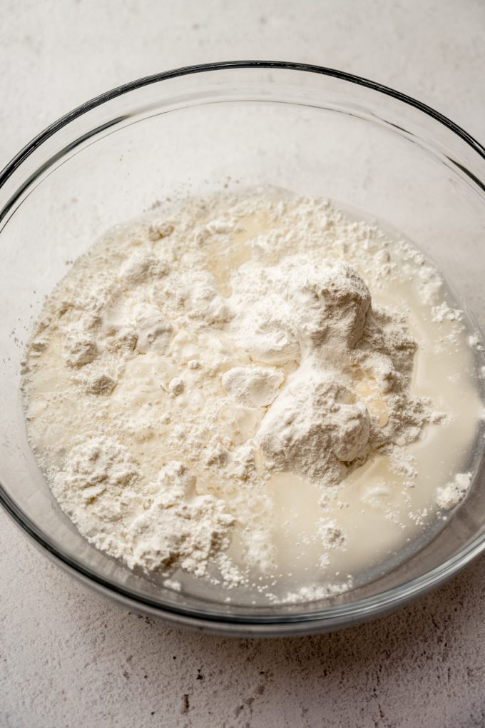 A glass bowl of the ingredients to make the sponge cake base for a Swiss roll cake.
