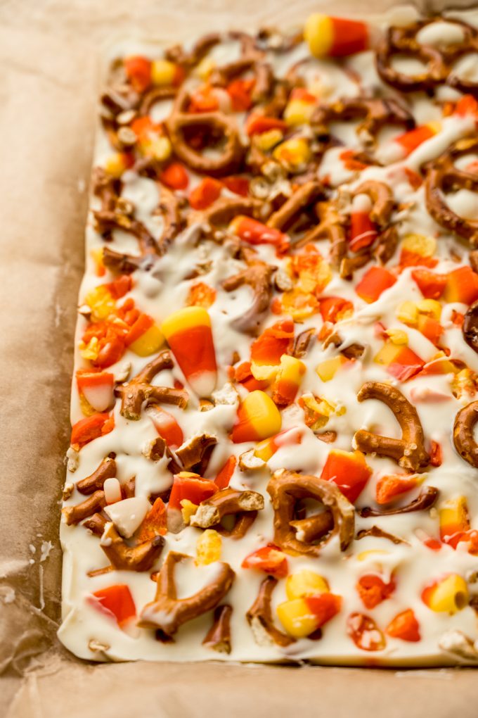 Candy corn bark on parchment paper before it's been broken into pieces.