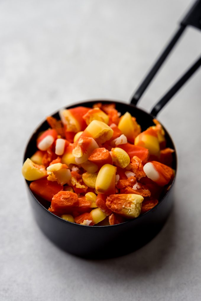 A measuring cup full of chopped candy corn.