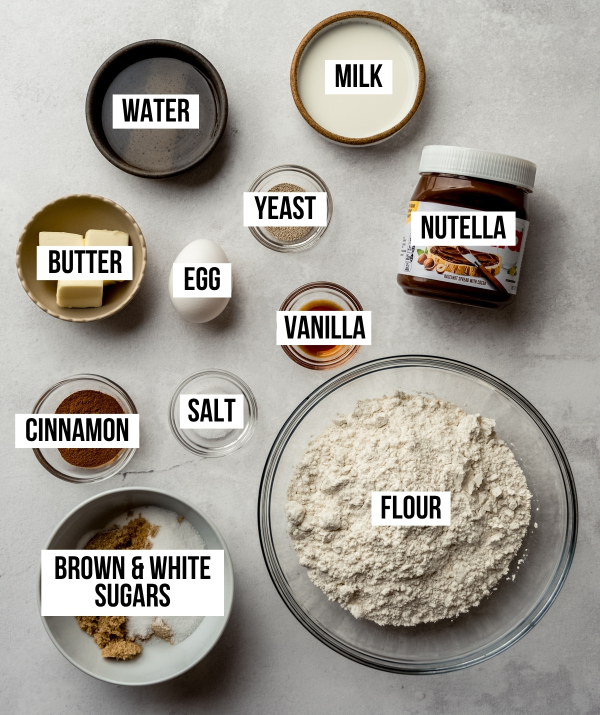 Aerial photo of ingredients to make Nutella rolls with text overlay labeling each ingredient.