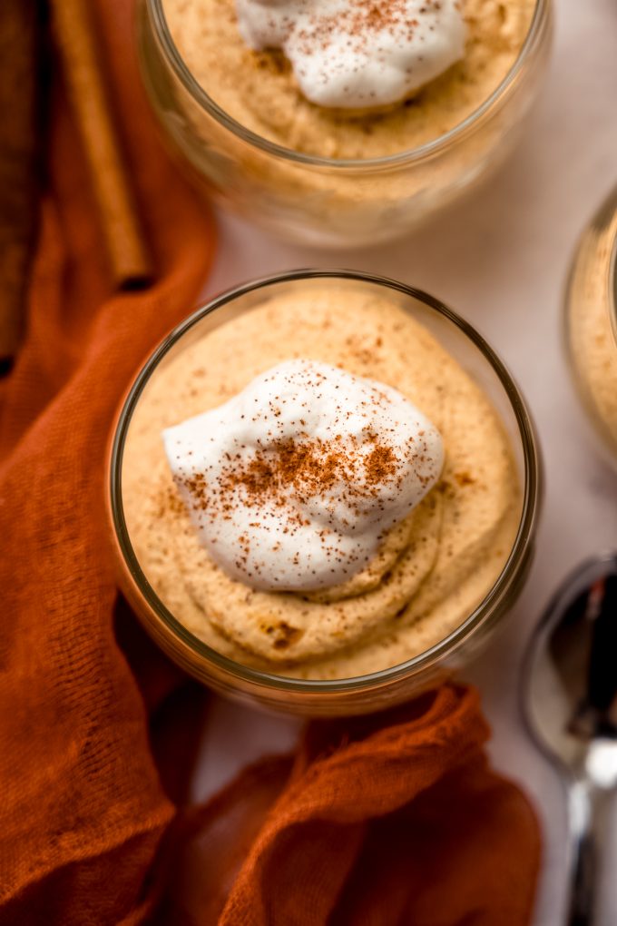 Aerial photo of a dessert cup with pumpkin mousse in it.