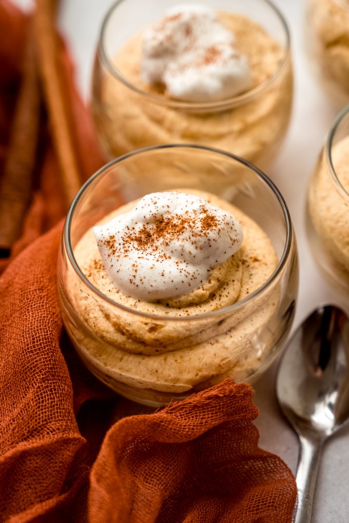 A dessert cup with pumpkin mousse in it.