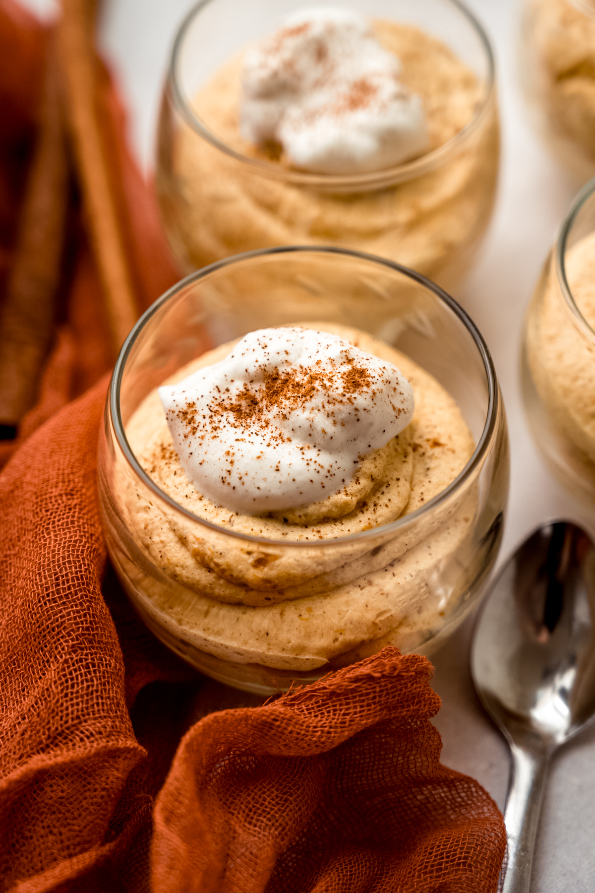 A dessert cup with pumpkin mousse in it.