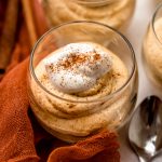 A dessert cup with pumpkin mousse in it.