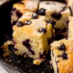Blueberry cornbread in a cast iron skillet.