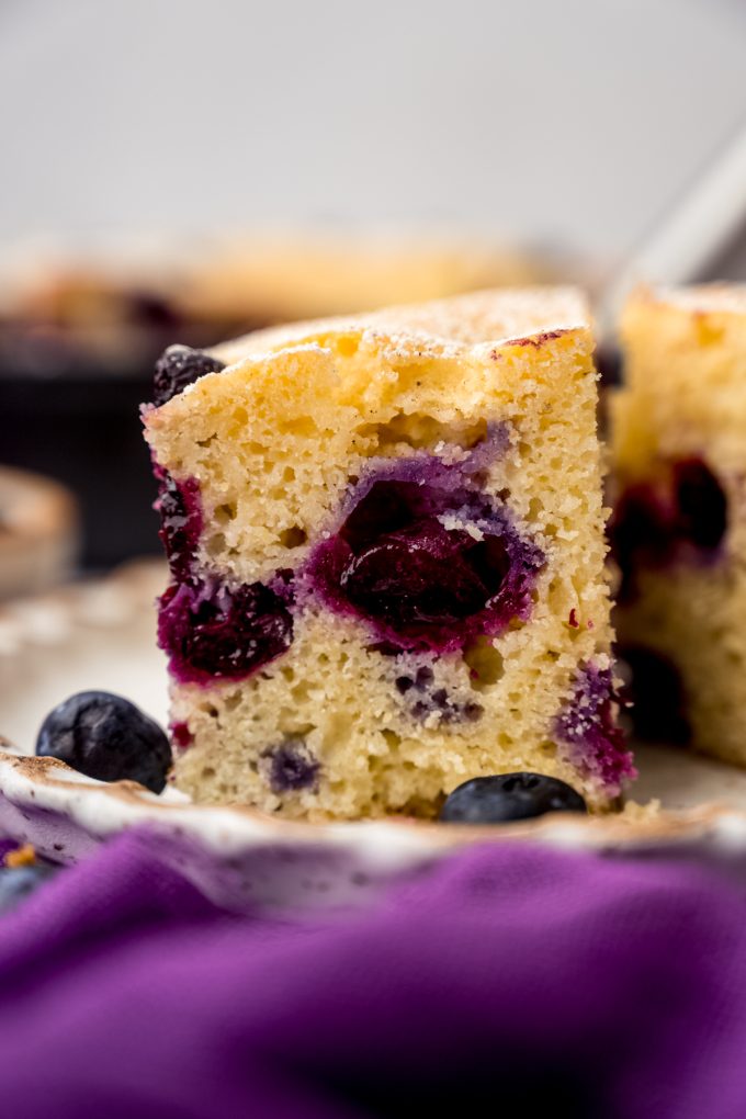 A slice of blueberry cornbread on a plate.