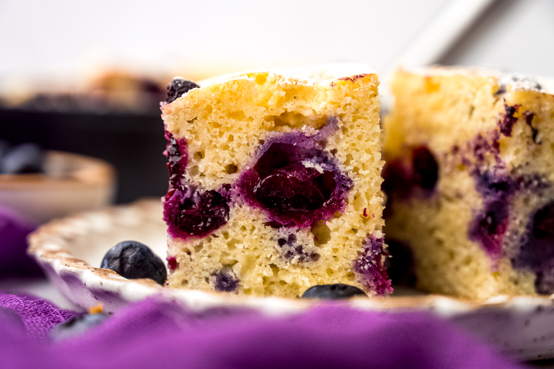 A slice of blueberry cornbread on a plate.