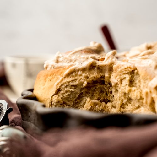 A baking dish with chai cinnamon rolls in it.
