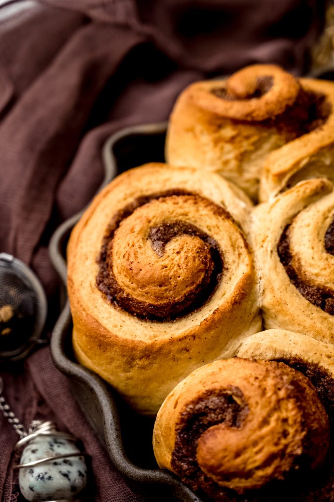 Chai cinnamon rolls in a baking dish.