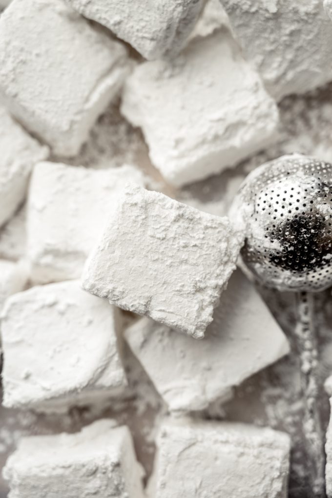 Homemade marshmallows on a surface.