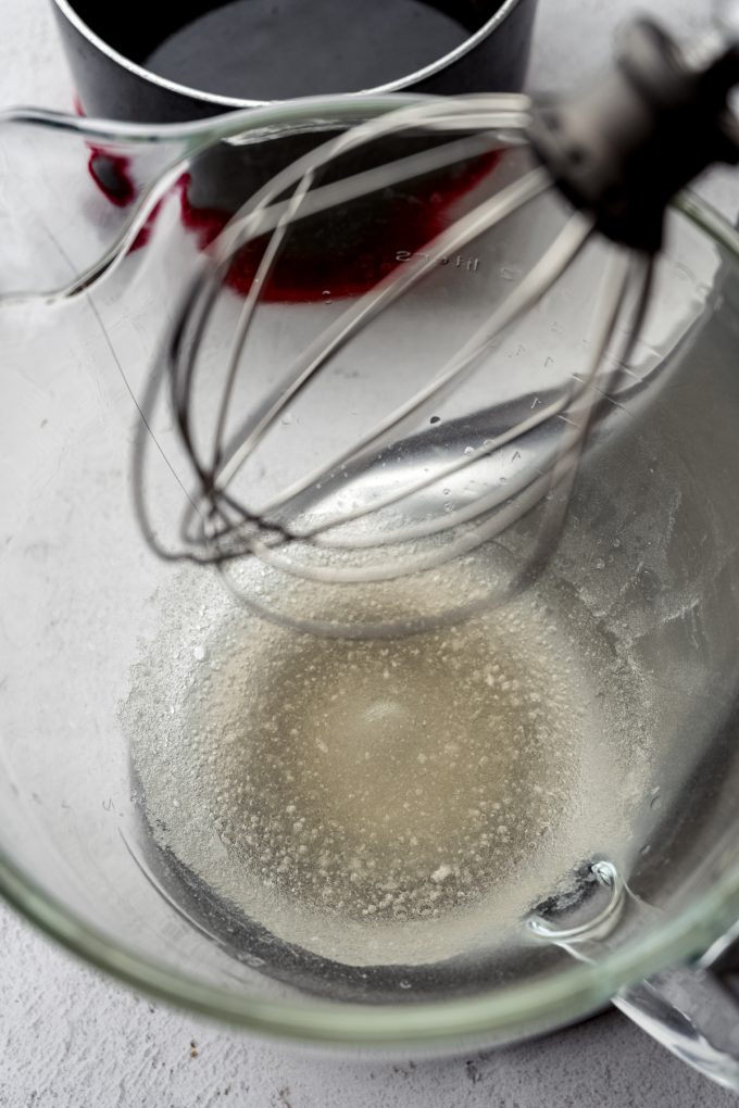 A mixing bowl with bloomed gelatin in the bottom of it.