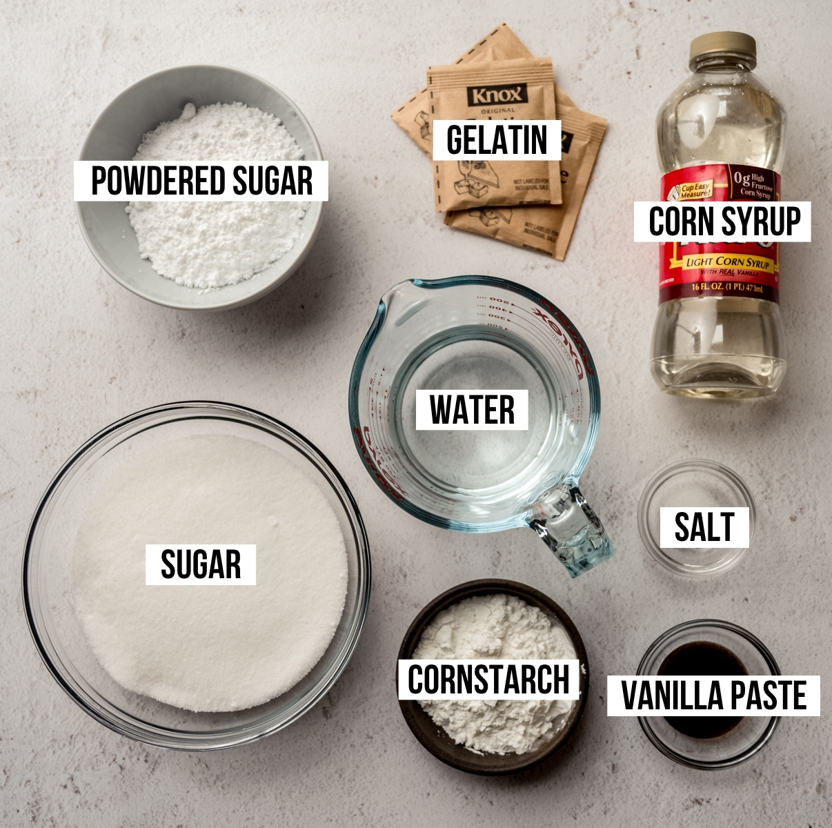 Aerial photo of ingredients to make homemade marshmallows with text overlay labeling each ingredient.