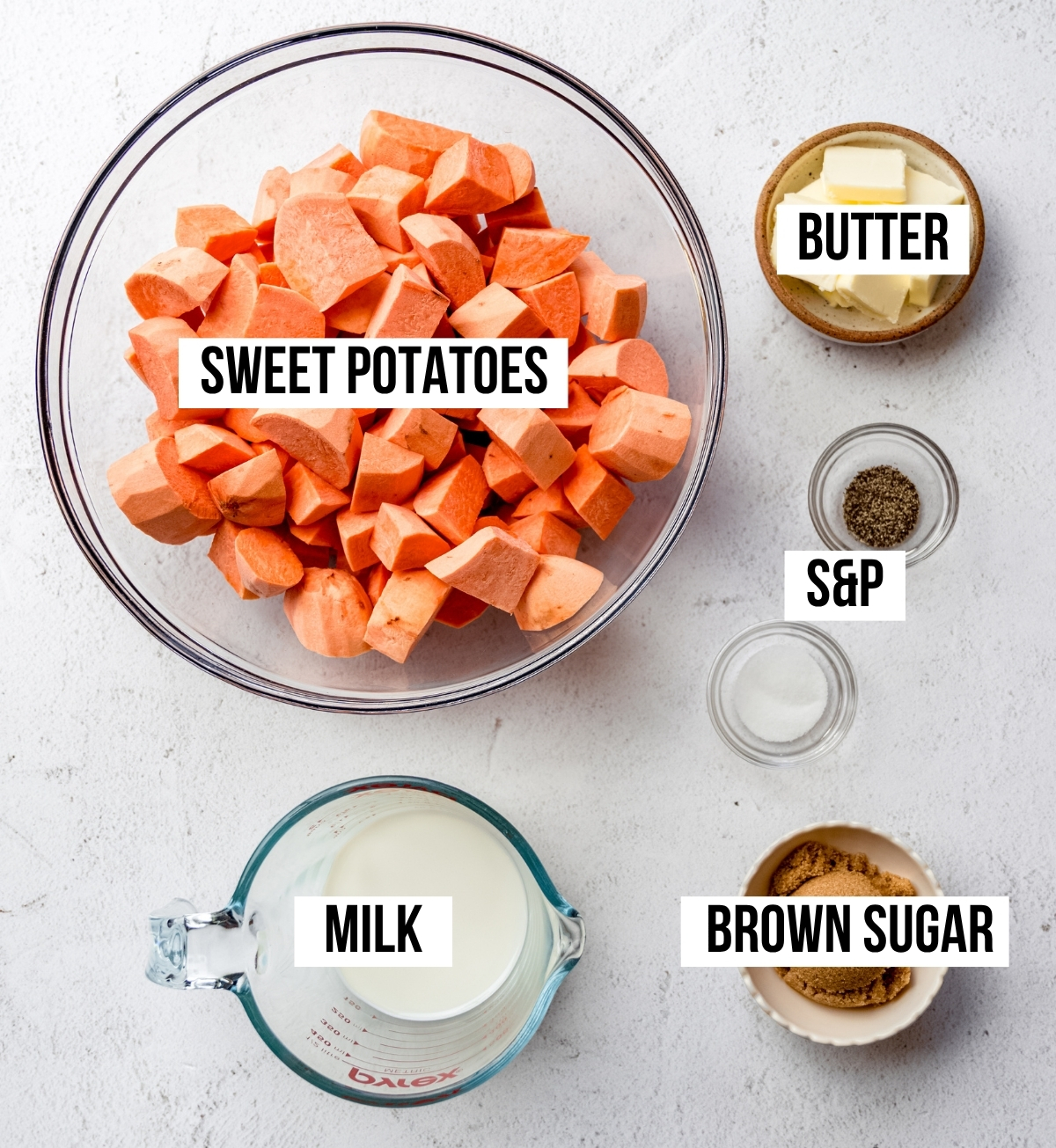 Aerial photo of ingredients to make mashed sweet potatoes with text overlay labeling each ingredient.