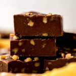 A stack of microwave fudge on a yellow kitchen towel.