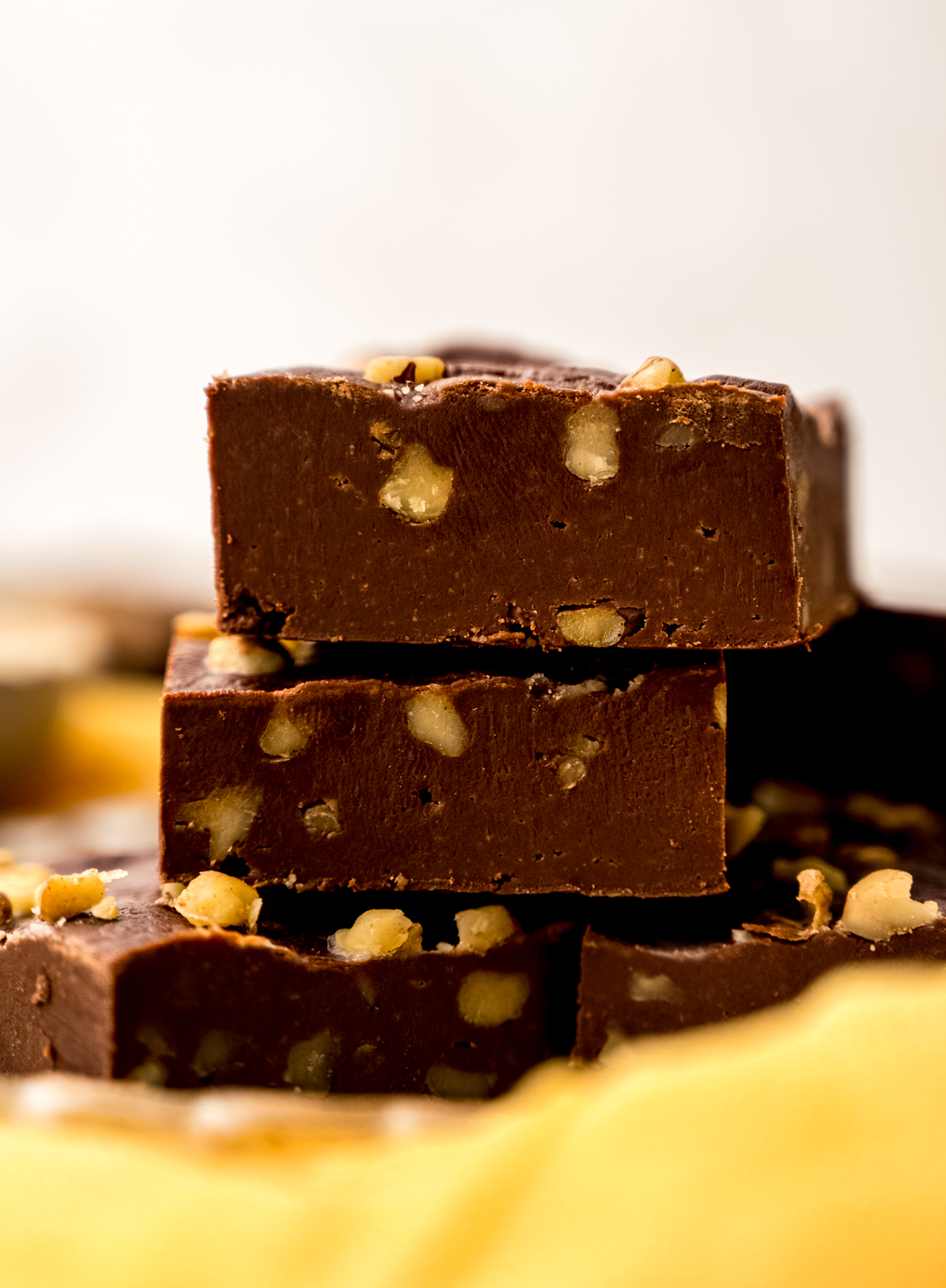 A stack of microwave fudge on a yellow kitchen towel.