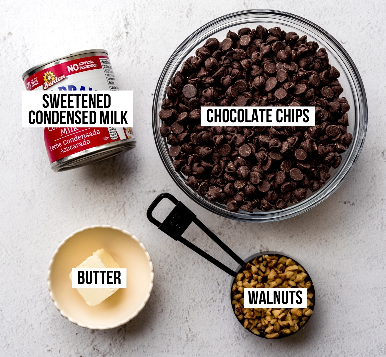 Aerial photo of ingredients to make microwave fudge with text overlay labeling each ingredient.
