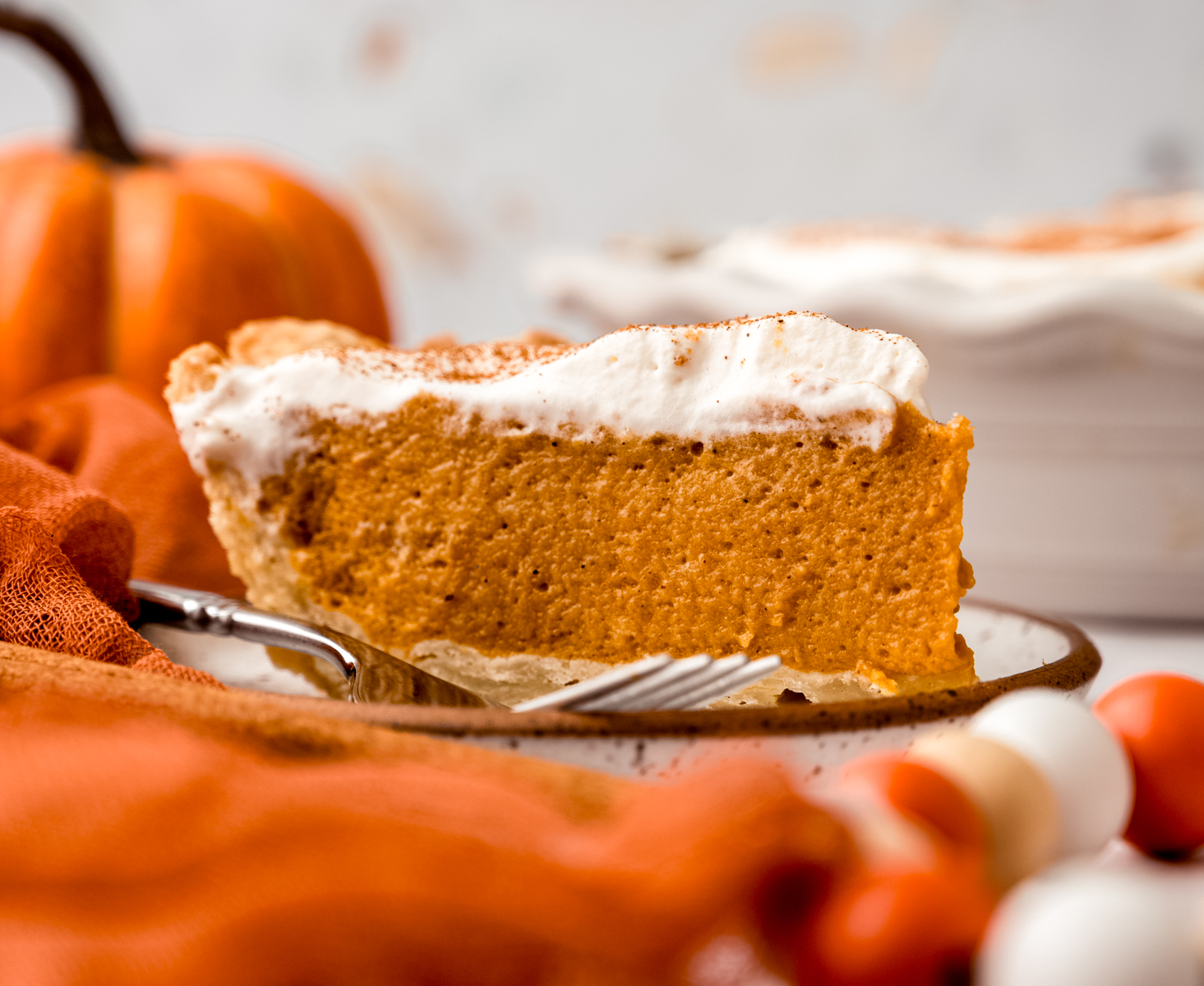 A slice of pumpkin chiffon pie on a plate.