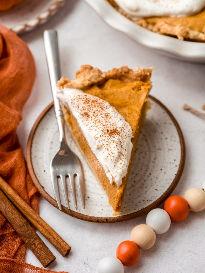 A slice of pumpkin chiffon pie on a plate.