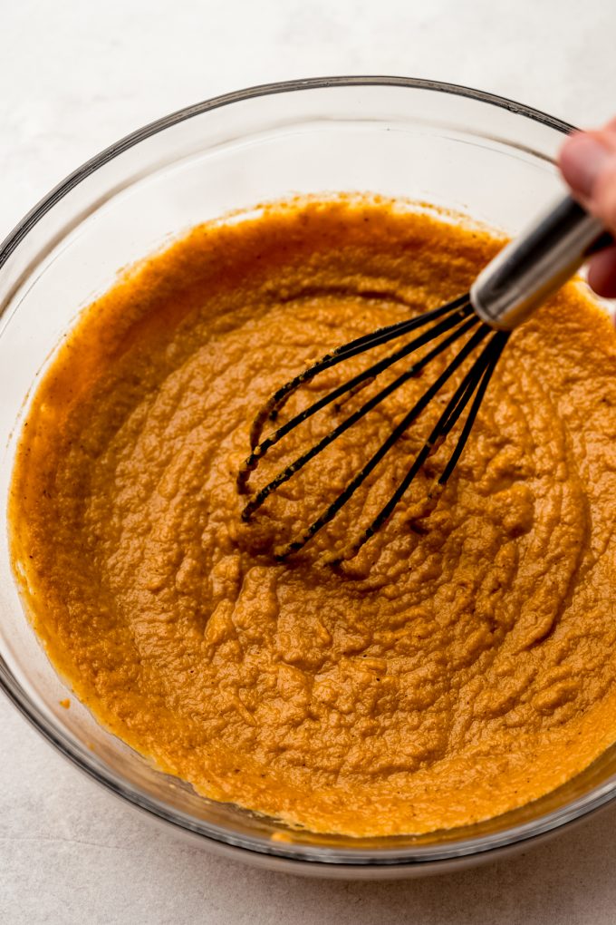 A bowl of the filling for pumpkin chiffon pie being whisked.