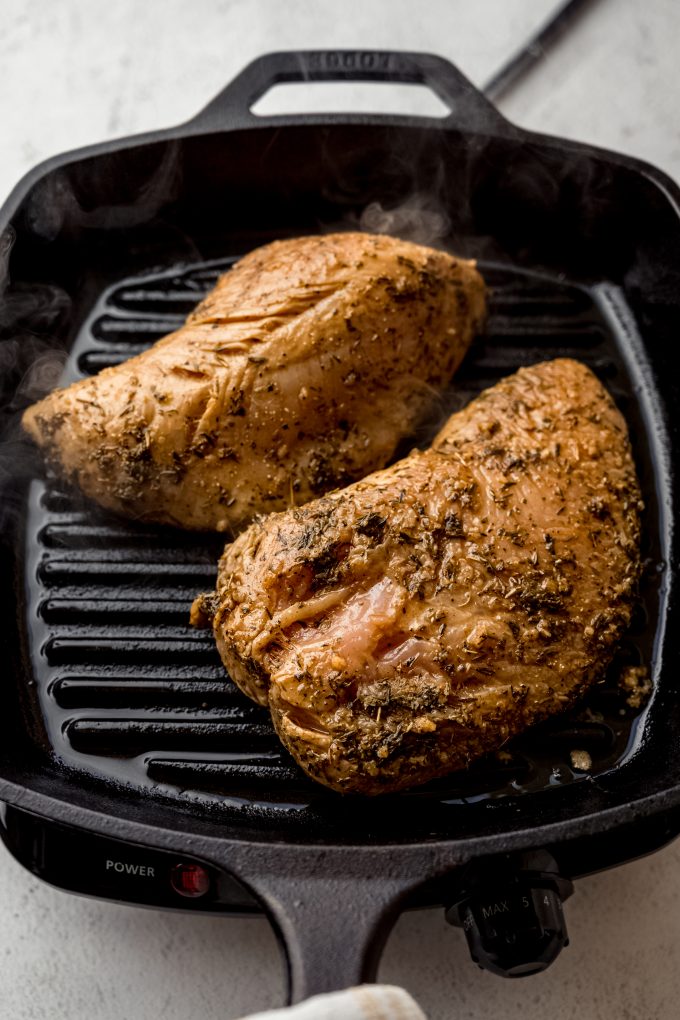 Turkey tenderloins on a cast iron skillet grill.