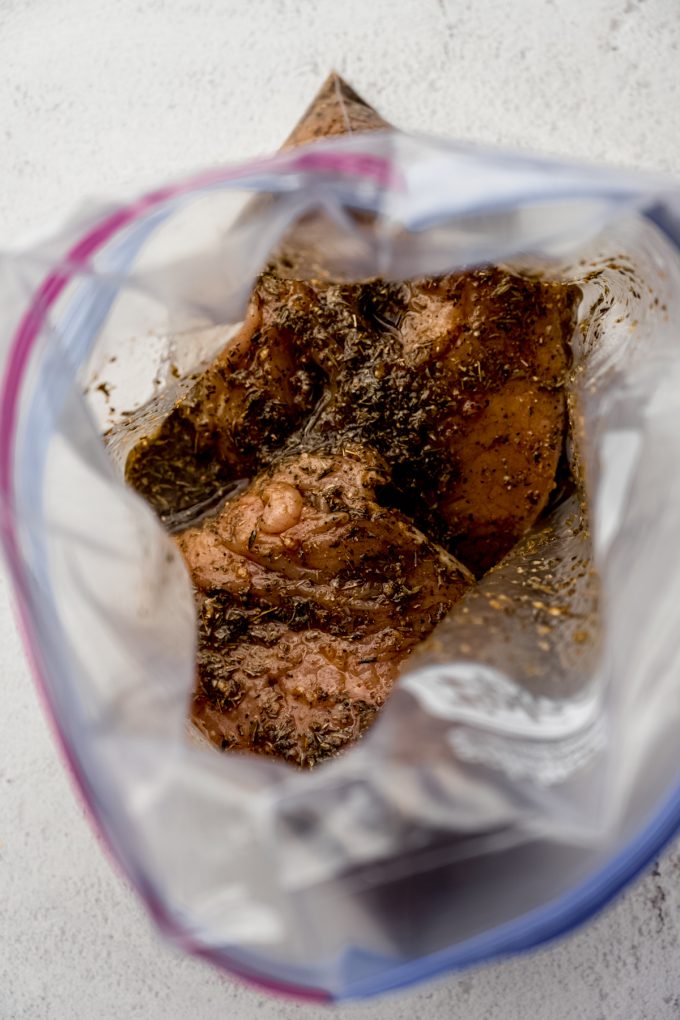 Aerial photo looking into a zip top bag with marinating turkey tenderloins in it.