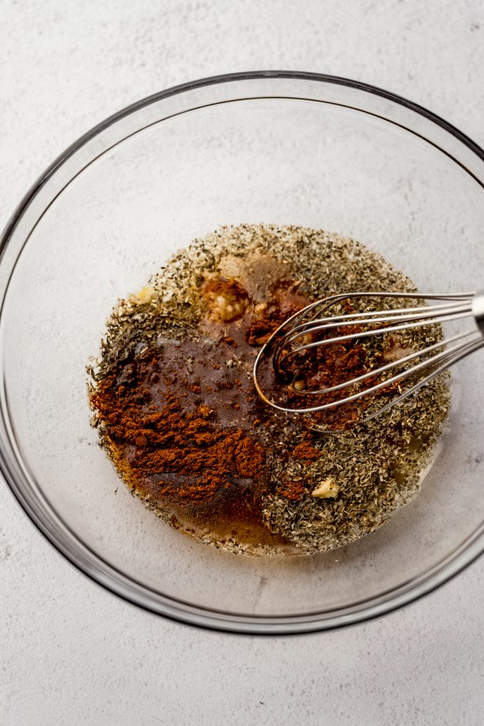 The ingredients for turkey tenderloin marinade in a bowl with a whisk.