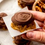 Someone is holding a homemade turtle candy.