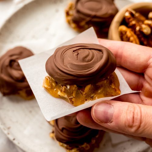 Someone is holding a homemade turtle candy.