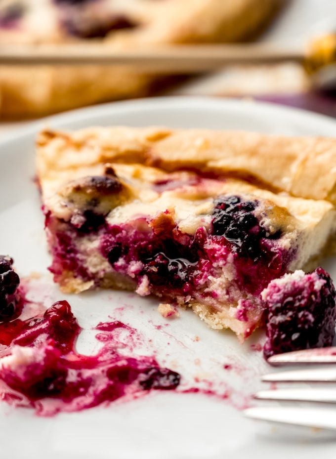 Blackberry galette on a plate with a fork.