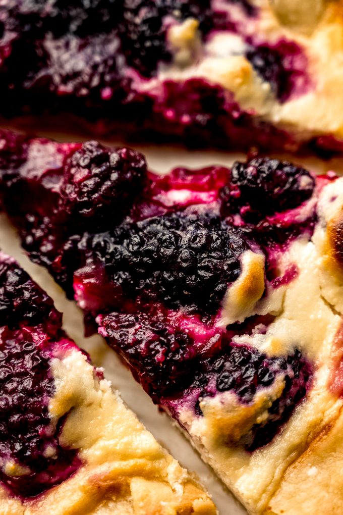 Aerial photo of a blackberry galette that has been sliced.