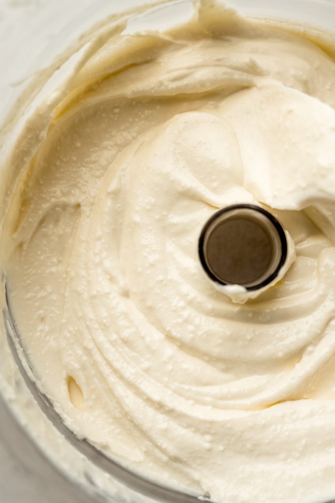 Whipped feta in the drum of a food processor.